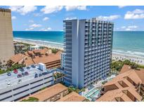 Oceanfront high-rise condo building with a swimming pool, parking garage, and views of the beach at 5511 N Ocean Blvd. # 209, Myrtle Beach, SC 29577