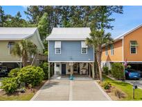 Charming raised beach house with coastal decor, ample parking, and convenient stair access at 77 Weatherboard Ct., Pawleys Island, SC 29585