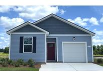Charming one-story home featuring blue siding, a red front door, and an attached one car garage at 870 Farmers Passage Loop, Loris, SC 29569