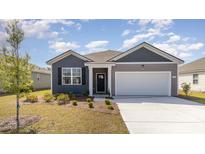 Charming single-story home features a two-car garage, gray accents, and inviting front yard landscaping at 882 Farmers Passage Loop, Loris, SC 29569