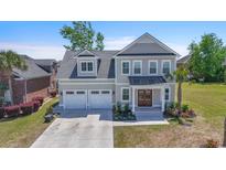 Beautiful two-story home with a two-car garage, landscaped yard, and charming front porch at 968 Shipmaster Ave., Myrtle Beach, SC 29579