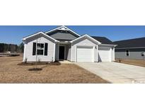 Charming single-story home with a two-car garage and manicured lawn at 977 Cherrystone Loop, Conway, SC 29526