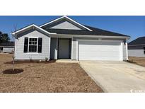 Charming single-story home with gray siding, black shutters, and a two-car garage at 981 Cherrystone Loop, Conway, SC 29526