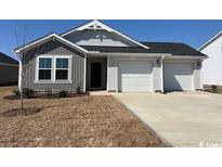 Charming single-story home with a two-car garage and well-maintained front lawn at 986 Cherrystone Loop, Conway, SC 29526