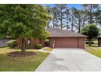 Charming one-story brick home with mature tree and manicured front yard at 114 Laurelwood Ln., Conway, SC 29526