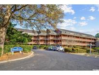 Exterior view of Arrowhead Court condos with well-maintained landscaping at 180 Rothbury Circle # 116, Myrtle Beach, SC 29572