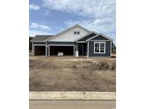 Newly constructed home with an attached three-car garage and dark blue and white siding at 190 Glengrove Lane, Murrells Inlet, SC 29576