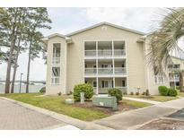 Inviting condo building with charming balconies, well-maintained landscaping, and ample parking at 201 Landing Rd. # D, North Myrtle Beach, SC 29582