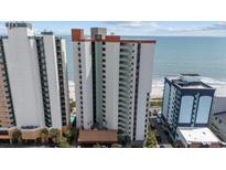 An exterior, high-angle view of a tall condominium building located near the beach and the ocean at 2701 N Ocean Blvd. # 561/563, Myrtle Beach, SC 29577