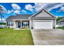 Charming single-story home featuring a well-manicured lawn, attached two-car garage, and lovely landscaping at 377 Copperwood Loop, Conway, SC 29526