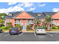 Inviting condo complex with well-manicured landscaping, private balconies, and convenient parking spaces at 4755 Lightkeepers Way # 15-E, Little River, SC 29566