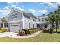 Charming two-story home with a manicured lawn, two car garage, and lush landscaping at 600 Waterbridge Blvd., Myrtle Beach, SC 29579