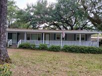 Charming single-story home featuring a welcoming front porch and a well-maintained lawn at 721 French Collins Rd., Conway, SC 29526