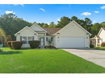 Charming single-story home features a well-manicured lawn, attached garage, and inviting curb appeal at 812 Buteo Ct., Myrtle Beach, SC 29588