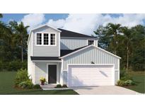 Charming two-story home featuring a white garage door, welcoming front entrance, and serene, light-blue siding at 1166 Silver Perch Place, Sunset Beach, NC 28468