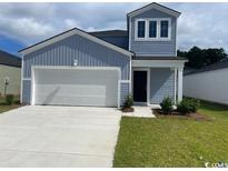 Charming two-story home with blue siding, attached garage and well-maintained lawn at 1166 Silver Perch Place, Sunset Beach, NC 28468