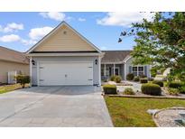 Well-maintained home with a two-car garage, driveway, and lush front yard landscaping at 207 Cupola Dr., Longs, SC 29568