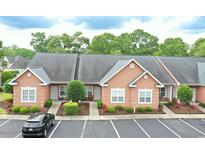 Inviting home exterior with a car parked in front, complemented by beautiful landscaping at 4660 Lightkeepers Way # 37B, Little River, SC 29566