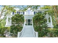 Traditional home featuring a welcoming front porch, grand staircase, and manicured landscaping at 486 Lantana Circle, Georgetown, SC 29440