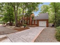 Brick home with a two-car garage, landscaped yard, and a long driveway at 618 6Th Ave. N, Surfside Beach, SC 29575