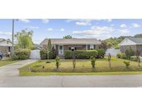 Charming single-story home with a well-manicured lawn and mature landscaping creating curb appeal at 706 Birch Ln., Conway, SC 29526
