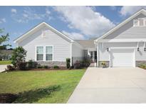 Charming single-story home featuring stone accents, manicured lawn, and a two-car garage at 830 San Marco Ct. # 2603-B, Myrtle Beach, SC 29579
