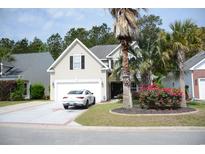 Charming home with manicured lawn, mature trees, and an attached two car garage and lovely garden at 1440 Brighton Ave., Myrtle Beach, SC 29588
