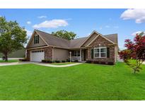 Charming home with brick and siding exterior, manicured lawn, and attached two-car garage at 1674 Sw Beach Dr., Calabash, SC 28467