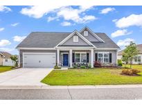 Charming single-story home with a manicured lawn, attached garage, and inviting front porch with rocking chairs at 240 Hillsborough Dr., Conway, SC 29526
