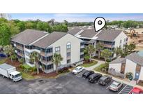 Exterior view of condominium building with landscaping, parking lot and construction area at 250 Maison Dr. # J-11, Myrtle Beach, SC 29572