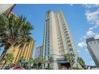 Stunning exterior shot of high-rise condo with palm trees and covered entrance at 2506 North Ocean Blvd. # 534, Myrtle Beach, SC 29577