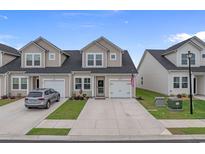 Inviting townhome with a well-manicured lawn and a charming, neutral-toned facade at 291 Brackish Dr. # 291, Myrtle Beach, SC 29588