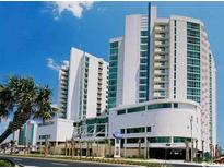 Beautiful multi-story resort featuring modern architecture, palm trees, and stunning blue skies at 300 N Ocean Blvd. # 1732, North Myrtle Beach, SC 29582