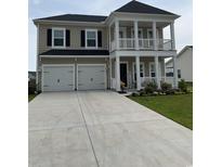 Charming two-story home featuring a spacious front yard, two-car garage, and a double porch at 3019 Visionary Dr., Myrtle Beach, SC 29588