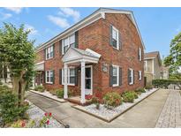 Charming brick exterior featuring manicured landscaping and a welcoming entrance with white columns at 401 77Th Ave. N # 11, Myrtle Beach, SC 29572