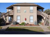 Inviting condo exterior featuring dual staircases and well-maintained landscaping, close to area amenities at 418 C Tree Top Ct. # 0, Myrtle Beach, SC 29588