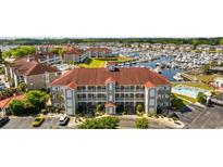 Stunning aerial view of complex with marina, multiple pools and well maintained landscaping at 4200 Coquina Harbour Dr. # H5, Little River, SC 29566