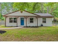 Charming single story home featuring a quaint front porch and a vibrant blue front door at 421 Villa Woods Dr., Myrtle Beach, SC 29579