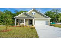 Charming single-story home with a manicured lawn, attached garage, and cozy front porch at 512 Haven View Way, Murrells Inlet, SC 29576