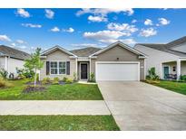 Charming single-story home featuring a two-car garage and beautifully landscaped front yard at 572 Woodland Farms Circle, Aynor, SC 29511
