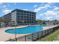 Large outdoor pool surrounded by lounge chairs at this condo complex by the beach at 5905 S Kings Hwy. # 314-B, Myrtle Beach, SC 29575