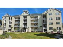 Beautiful condominium featuring balconies, lush landscaping, and a charming building design at 601 Hillside Dr. N # 1405, North Myrtle Beach, SC 29582