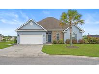 Charming one-story home features blue siding, a well-manicured lawn, and a mature palm tree at 713 Garland Ct., Myrtle Beach, SC 29588