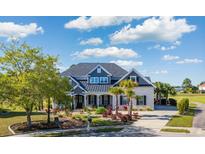 Stunning two-story home with landscaped yard, beautiful trees and a long driveway at 1017 Gallinule Dr., Conway, SC 29526