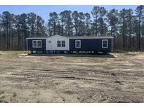New construction home featuring dark siding, white trim, and a spacious yard at 116 Forman Way, Aynor, SC 29511