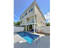 Relaxing pool with fenced-in backyard provides privacy, a perfect outdoor space for entertaining and lounging at 118A 6Th Ave. N, Surfside Beach, SC 29575
