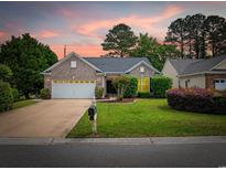 Charming brick home with a well-manicured lawn and mature trees, perfect for curb appeal at 1504 Sedgefield Dr., Murrells Inlet, SC 29576
