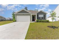 Charming single story home with a two car garage and manicured lawn at 1804 Castlebay Dr., Conway, SC 29526
