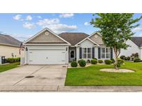 Charming single-story home with a well-manicured lawn and attached two-car garage at 195 Cupola Dr., Longs, SC 29568