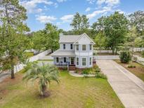 Charming two-story home with a well-manicured lawn, picket fence and a spacious driveway at 221 Lander Dr., Conway, SC 29526